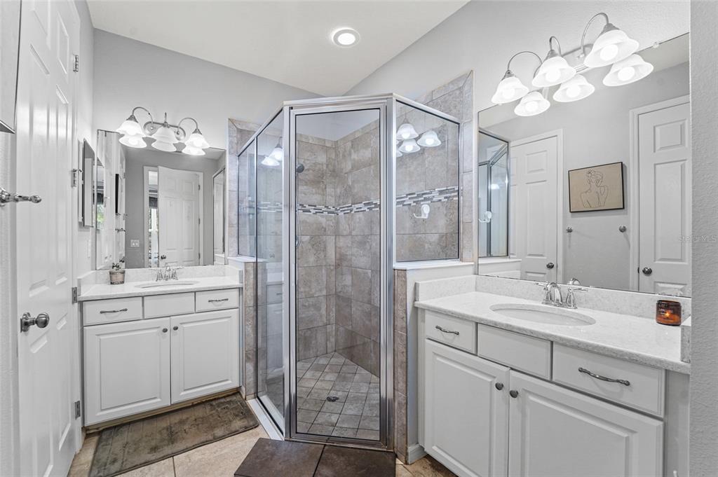 8903 Arabella Lane Seminole, FL 33777 - Photo 14 of 47 a bathroom with a double vanity sink mirror and shower
