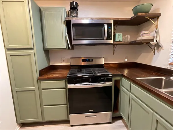 a kitchen with a stove and a microwave
