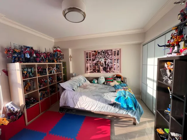 a bed room with furniture and a flat screen tv