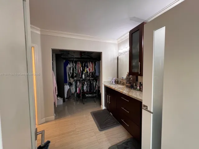 a hallway with a closet and a window