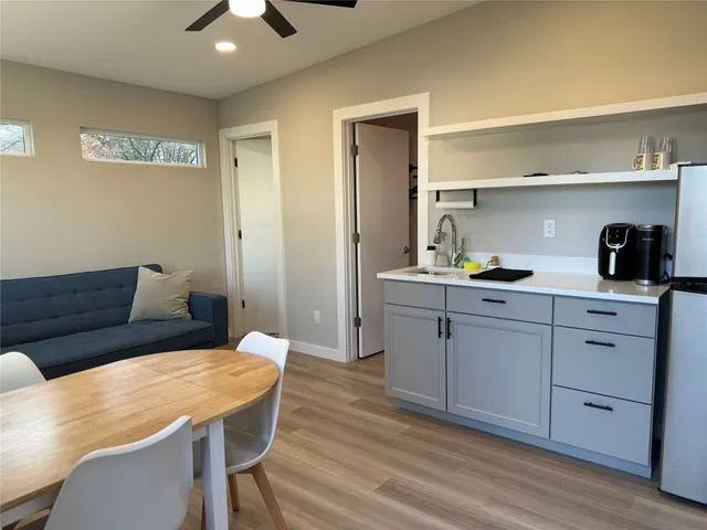 a kitchen with refrigerator and cabinets