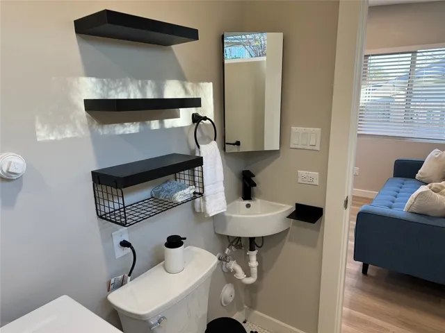 a large bed sitting in a bedroom next to a window