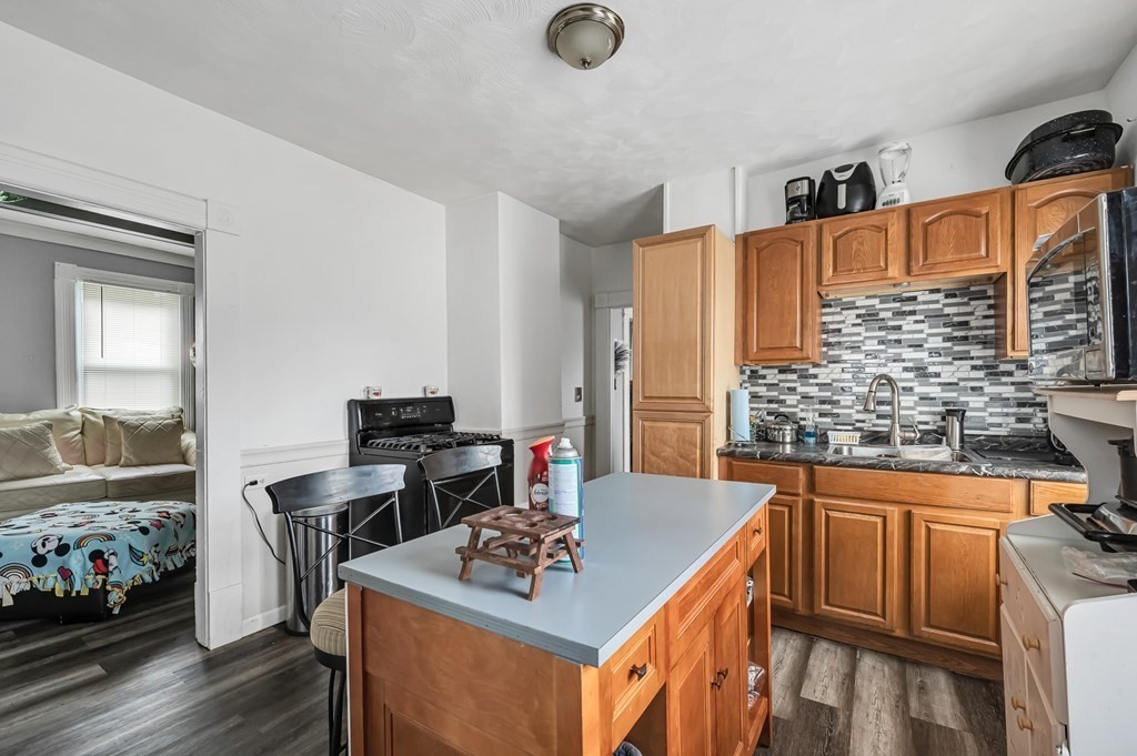 21 Pasadena Street Springfield, MA 01108 - Photo 8 of 32 a kitchen with stainless steel appliances granite countertop a stove and a sink