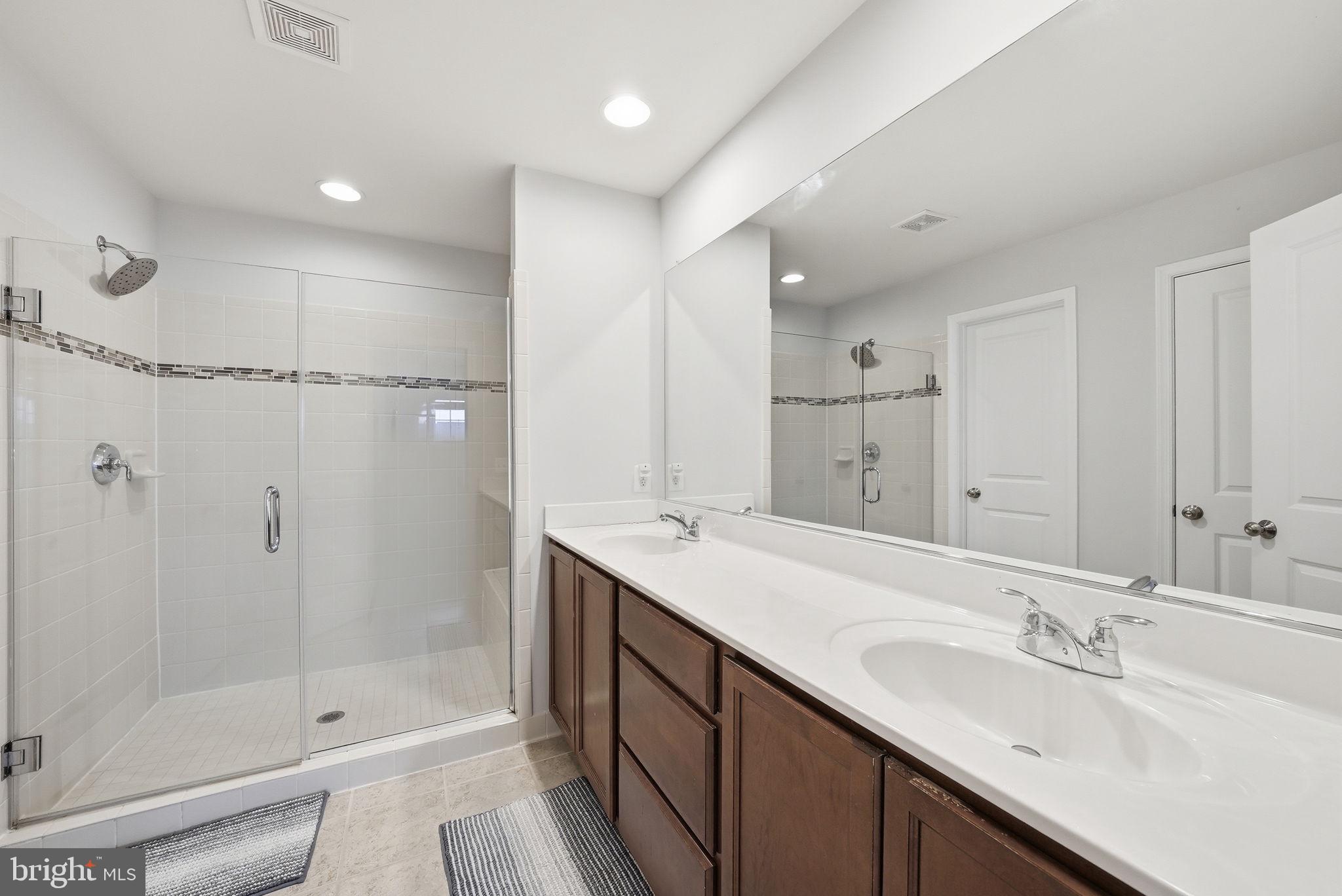 214 Shields Road Stafford, VA 22554 - Photo 30 of 47 Sleek modern bathroom with dual sinks.