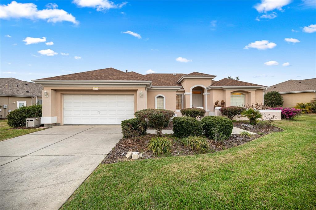 9512 Southeast 124th Loop Summerfield, FL 34491 - Photo 1 of 76 a front view of a house with a yard