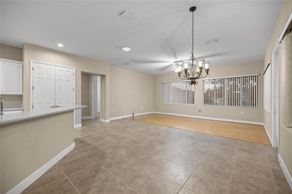 9512 Southeast 124th Loop Summerfield, FL 34491 - Photo 12 of 76 a view of a livingroom with a chandelier cabinets and a kitchen island