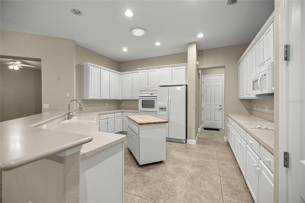 9512 Southeast 124th Loop Summerfield, FL 34491 - Photo 14 of 76 a kitchen with a sink stove and refrigerator