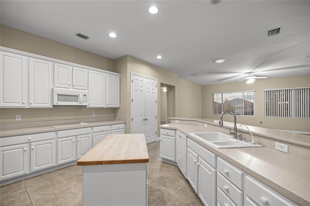 9512 Southeast 124th Loop Summerfield, FL 34491 - Photo 15 of 76 a large kitchen with kitchen island a sink stainless steel appliances and cabinets