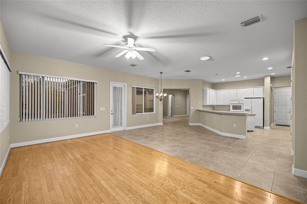 9512 Southeast 124th Loop Summerfield, FL 34491 - Photo 18 of 76 a view of an empty room with kitchen and window
