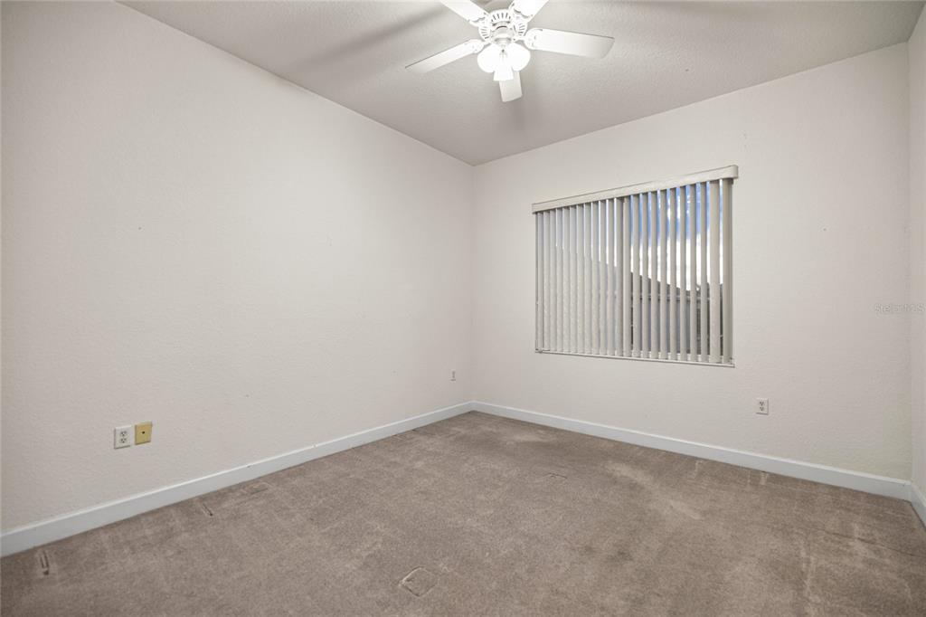 9512 Southeast 124th Loop Summerfield, FL 34491 - Photo 19 of 76 an empty room with a chandelier fan