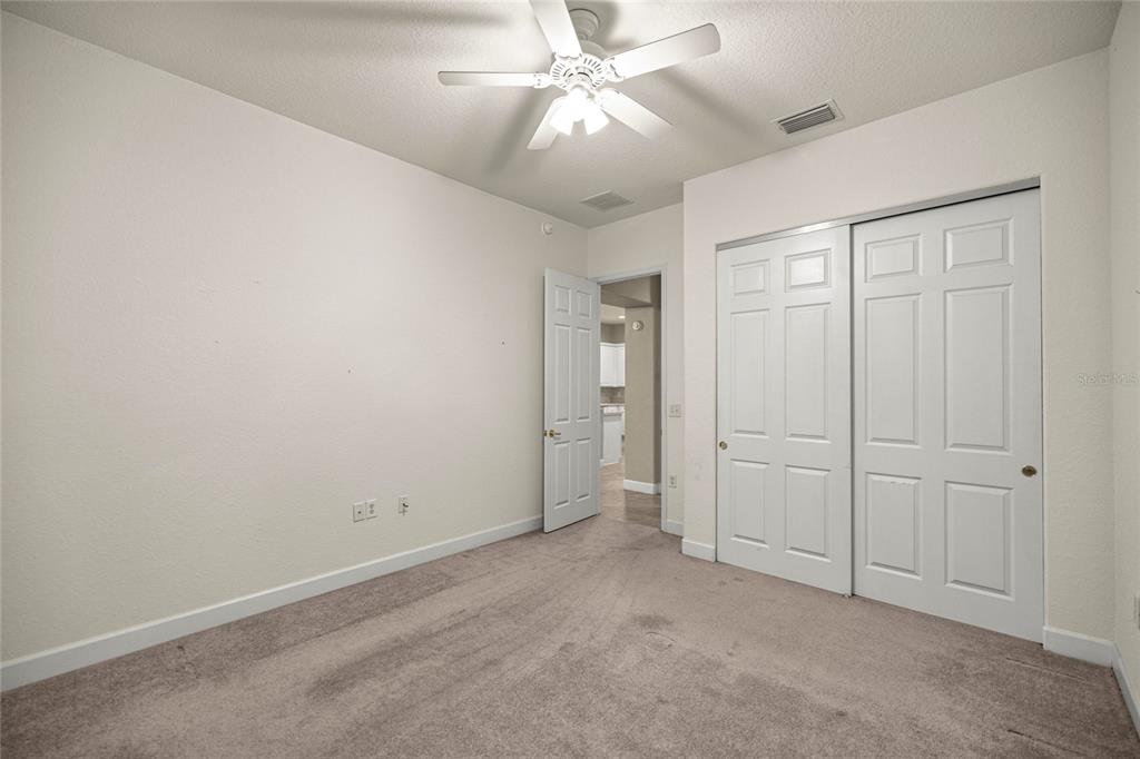 9512 Southeast 124th Loop Summerfield, FL 34491 - Photo 20 of 76 an empty room with closet and fan
