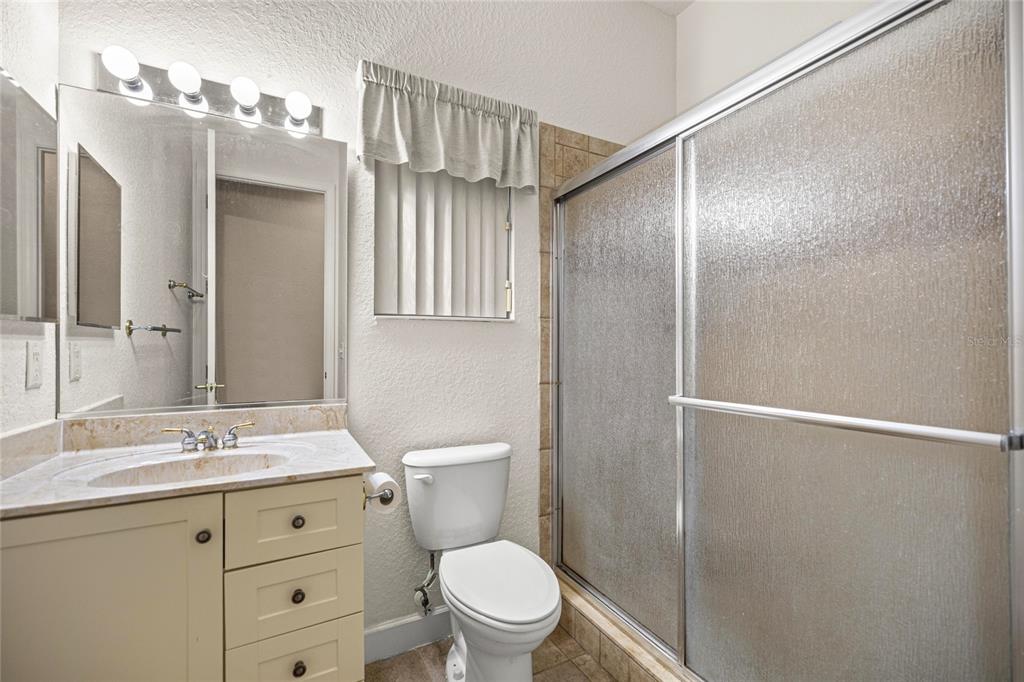 9512 Southeast 124th Loop Summerfield, FL 34491 - Photo 21 of 76 a bathroom with a granite countertop sink toilet and shower