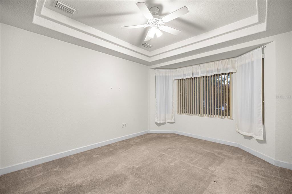 9512 Southeast 124th Loop Summerfield, FL 34491 - Photo 25 of 76 an empty room with windows and fan