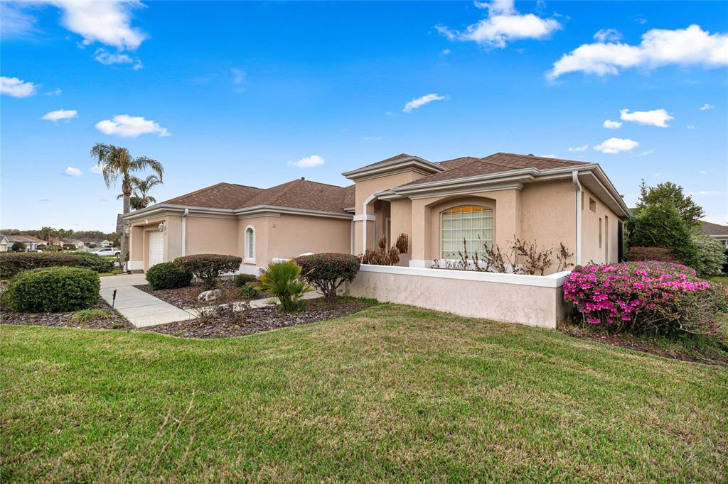 9512 Southeast 124th Loop Summerfield, FL 34491 - Photo 4 of 76 a view of a house with backyard sitting area and garden
