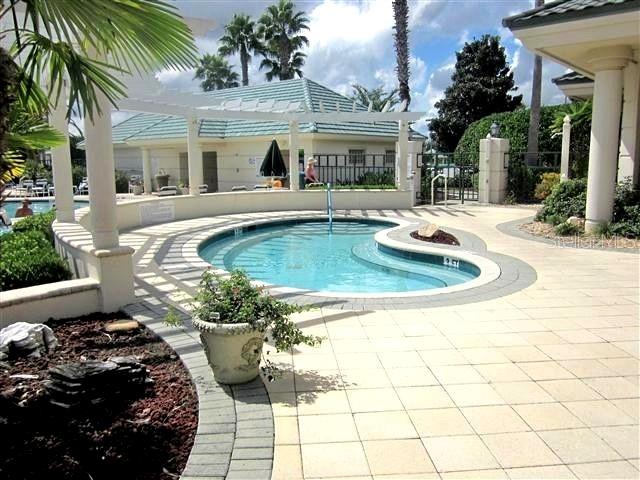 9512 Southeast 124th Loop Summerfield, FL 34491 - Photo 44 of 76 a view of a house with backyard swimming pool and sitting area