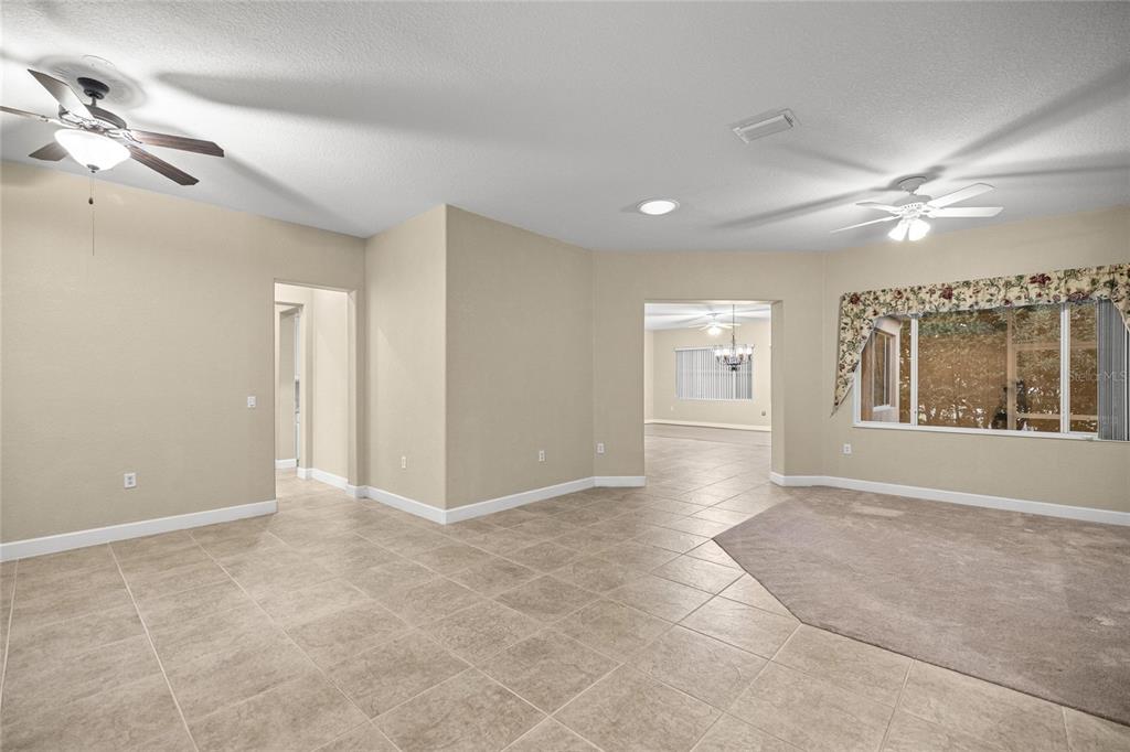 9512 Southeast 124th Loop Summerfield, FL 34491 - Photo 6 of 76 a view of an empty room with window and chandelier fan
