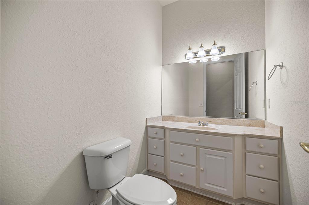 9512 Southeast 124th Loop Summerfield, FL 34491 - Photo 10 of 76 a bathroom with a toilet sink and mirror