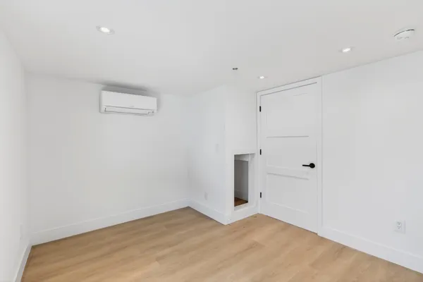 a open kitchen with granite countertop a stove top oven a sink and a large window