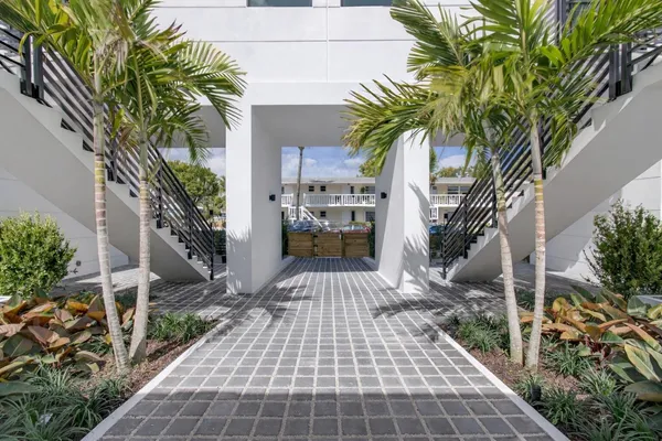 a view of a couches in the patio with potted plants