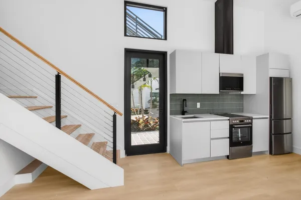 a kitchen with a stove top oven and cabinets
