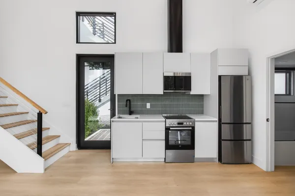 a view of a kitchen with washer and dryer