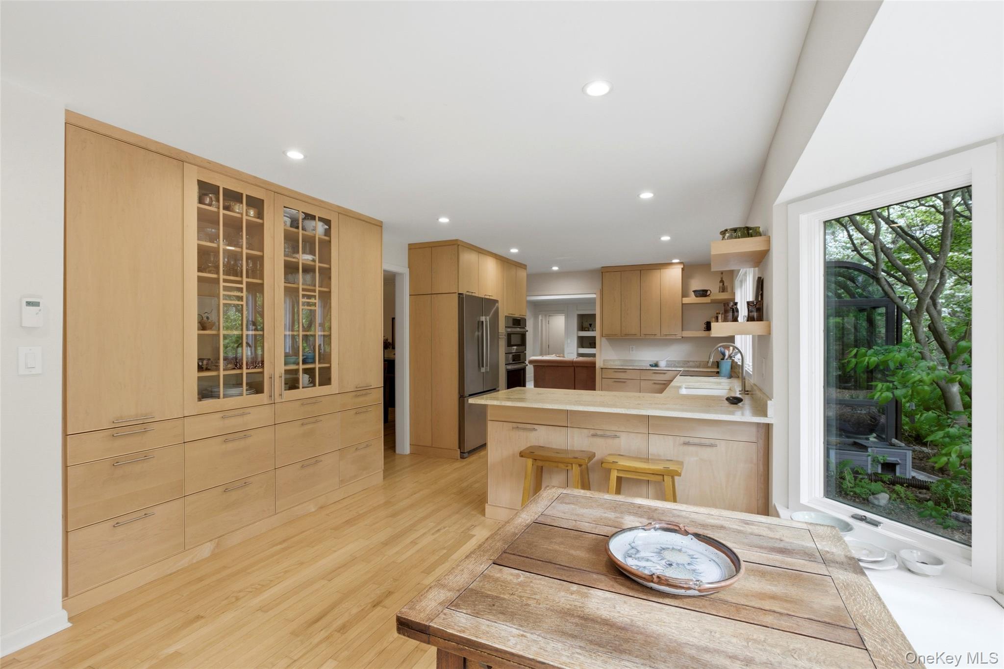 7 Gun Path Setauket, NY 11733 - Photo 16 of 34 a large kitchen with kitchen island a large window cabinets a sink and stainless steel appliances