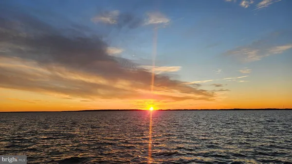 a kitchen with stainless steel appliances a stove a refrigerator and a dining table