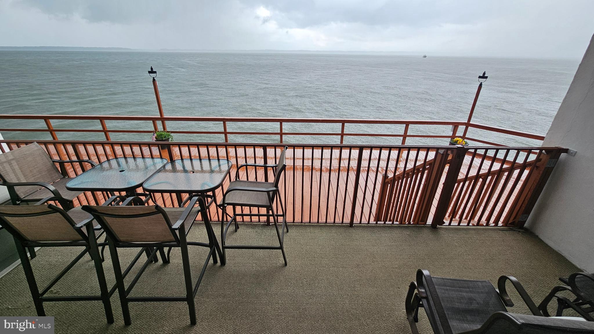 745 Mooring Road, Unit 111 Ocean City, MD 21842 - Photo 3 of 24 a view of a chairs and table in the balcony