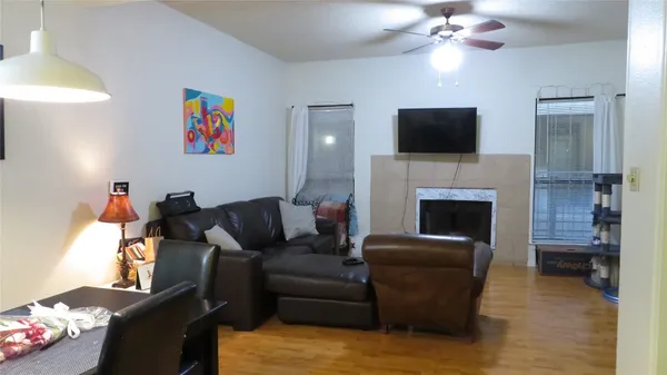 a living room with furniture a flat screen tv and a fireplace