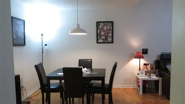 a view of a dining room with furniture and a chandelier