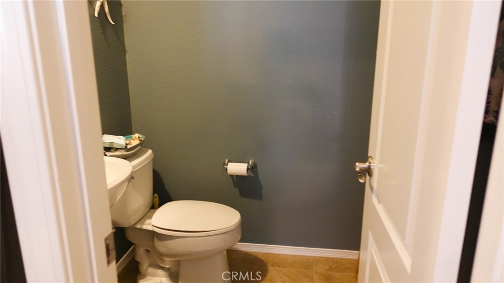 33953 Lily Road Yucaipa, CA 92399 - Photo 11 of 38 a white toilet sitting next to a small sink
