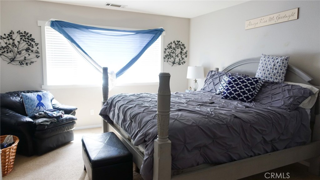 33953 Lily Road Yucaipa, CA 92399 - Photo 17 of 38 a bedroom with a bed window and a couch