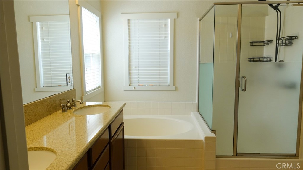 33953 Lily Road Yucaipa, CA 92399 - Photo 21 of 38 a bathroom with a tub sink and a mirror