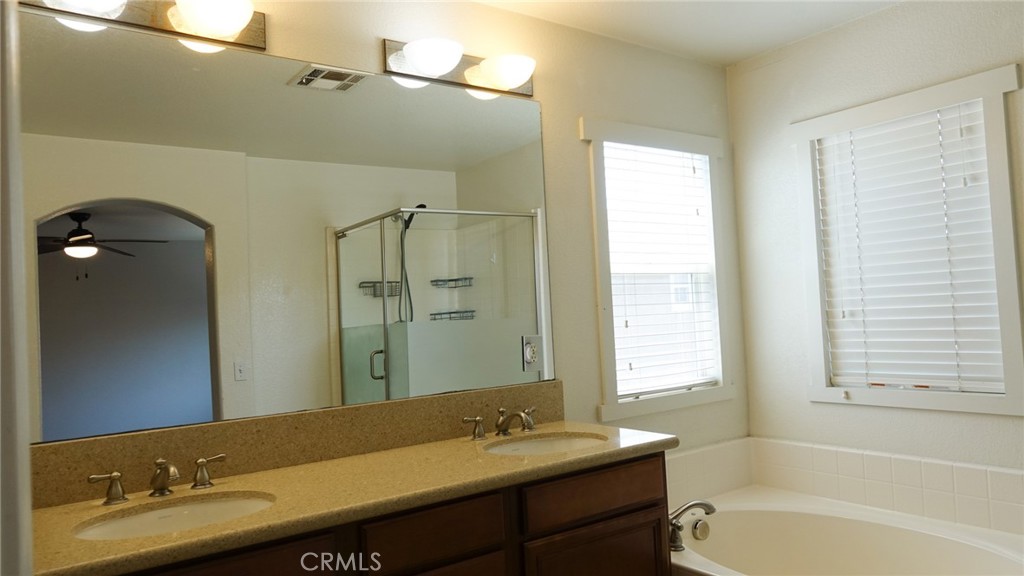 33953 Lily Road Yucaipa, CA 92399 - Photo 22 of 38 a bathroom with a granite countertop sink tub and a mirror