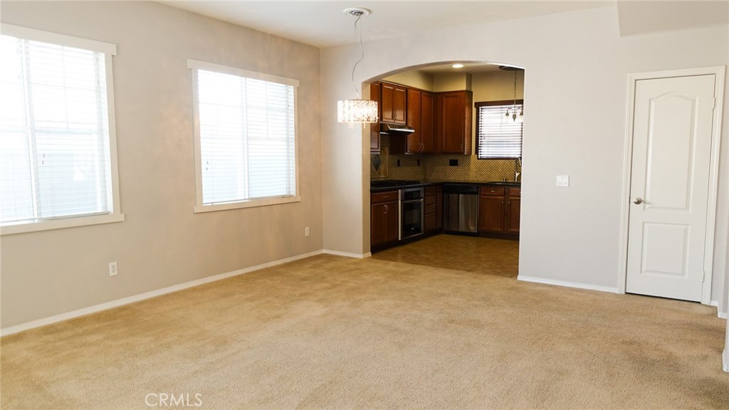 33953 Lily Road Yucaipa, CA 92399 - Photo 8 of 38 an empty room with windows and cabinet