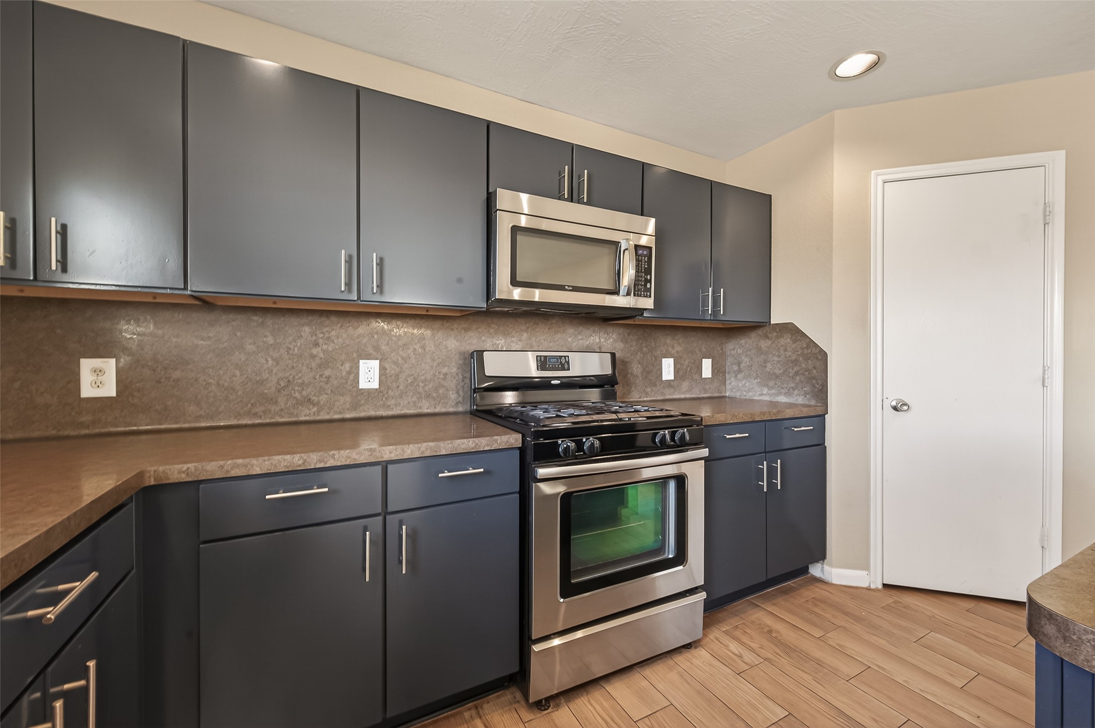 4515 Apache Point Drive Humble, TX 77396 - Photo 13 of 36 a kitchen with stainless steel appliances granite countertop a stove a microwave and a sink