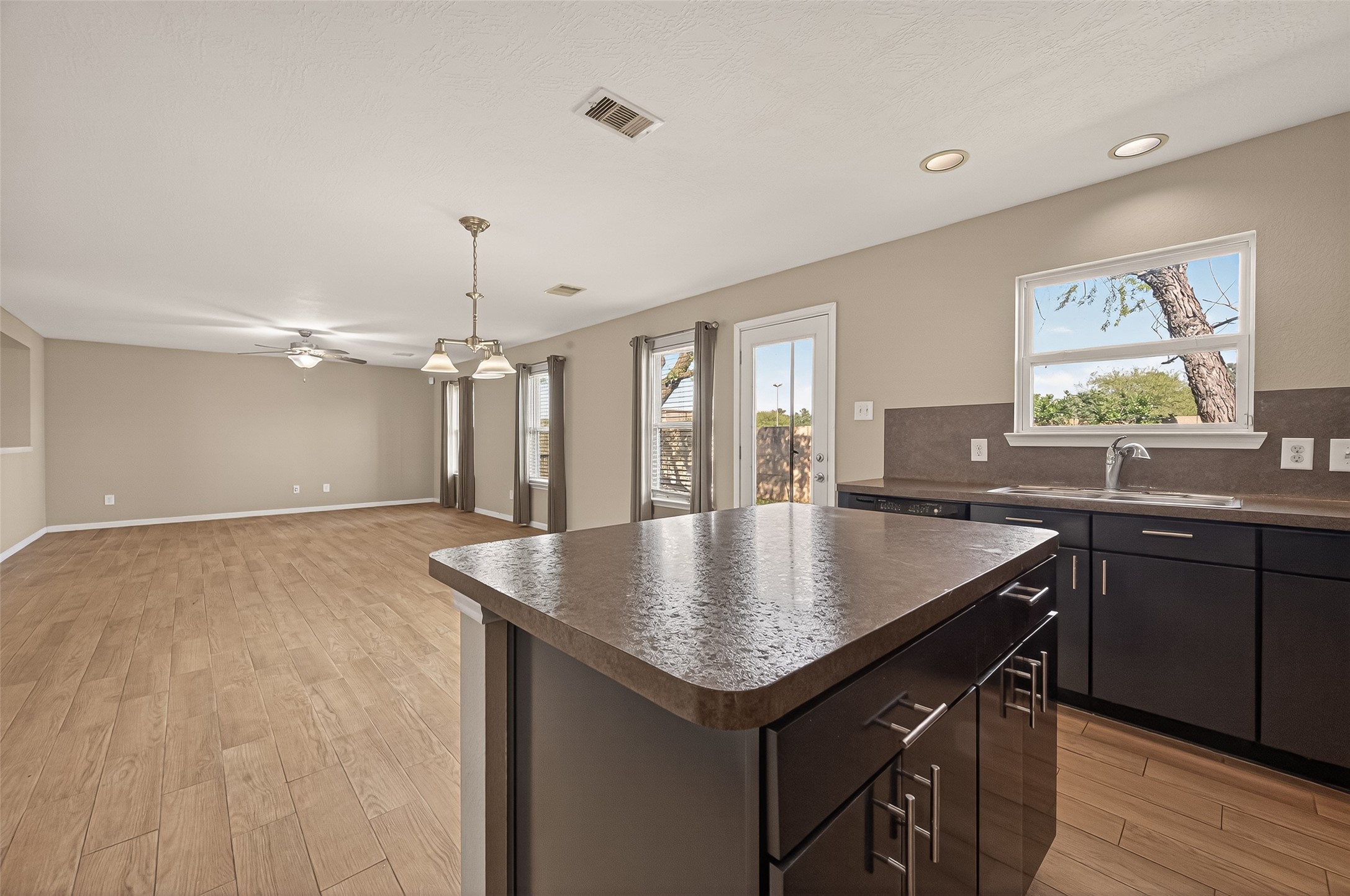 4515 Apache Point Drive Humble, TX 77396 - Photo 15 of 36 a kitchen with a table chairs and wooden floor