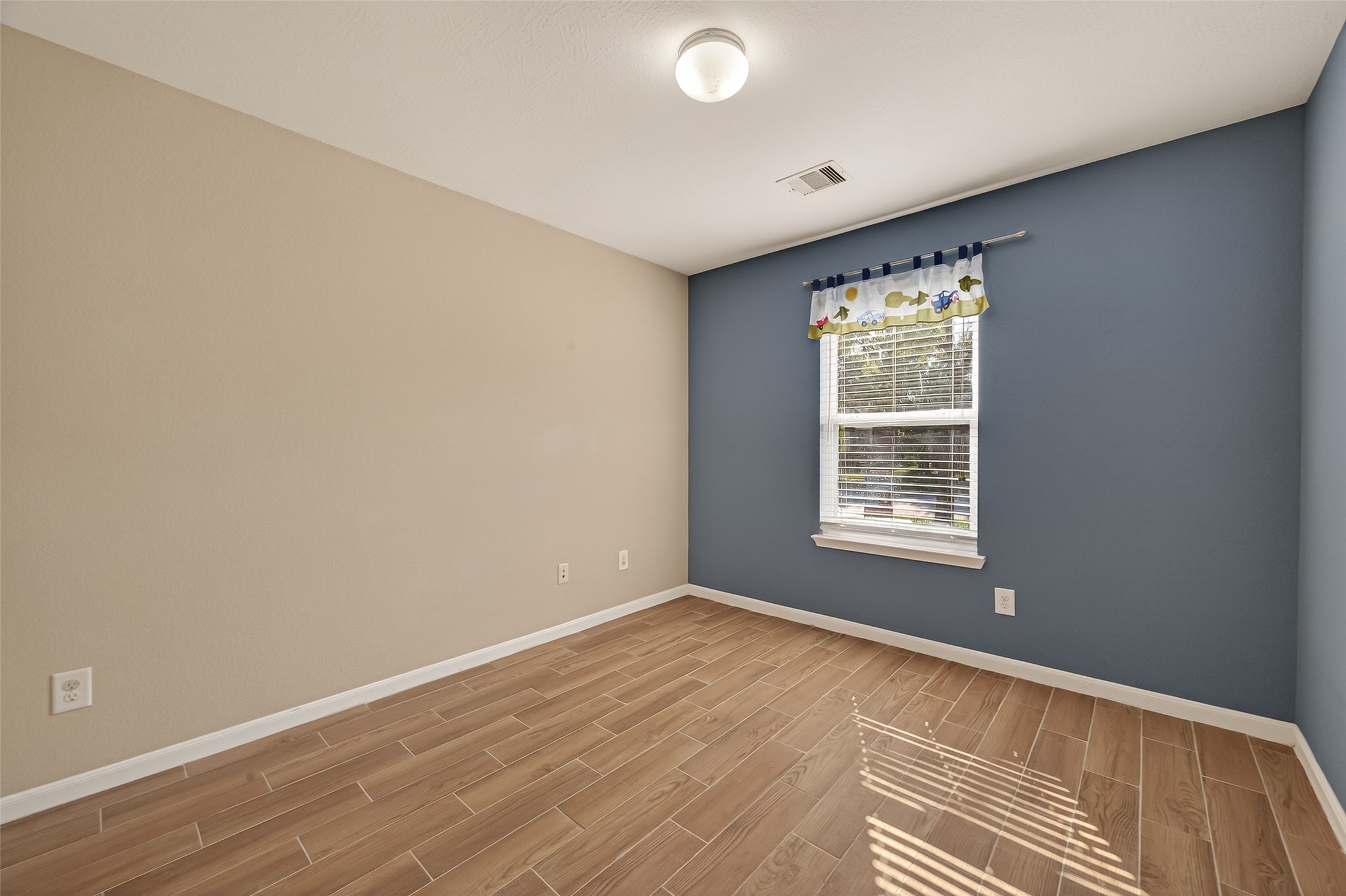 4515 Apache Point Drive Humble, TX 77396 - Photo 20 of 36 an empty room with wooden floor and windows