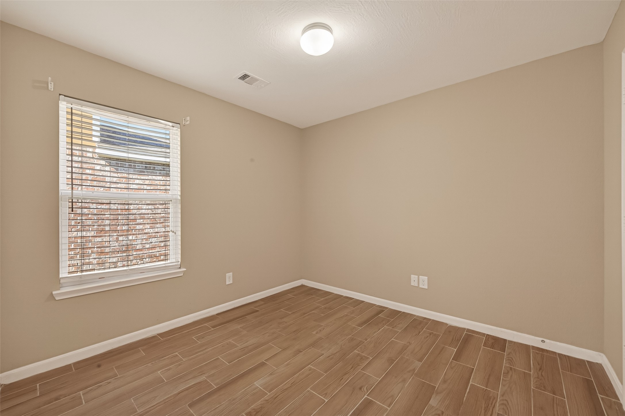 4515 Apache Point Drive Humble, TX 77396 - Photo 22 of 36 wooden floor in an empty room with a window