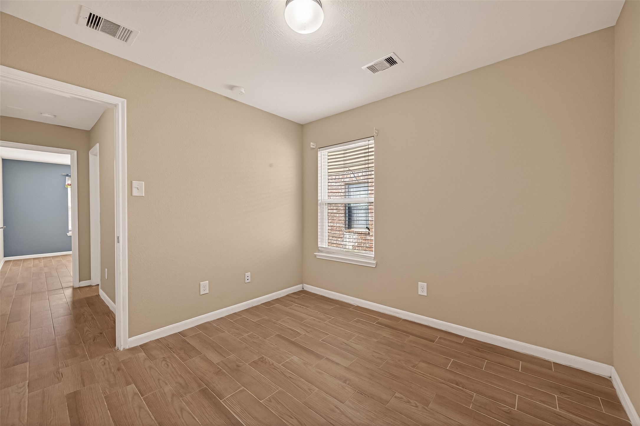 4515 Apache Point Drive Humble, TX 77396 - Photo 24 of 36 wooden floor in an empty room with a window