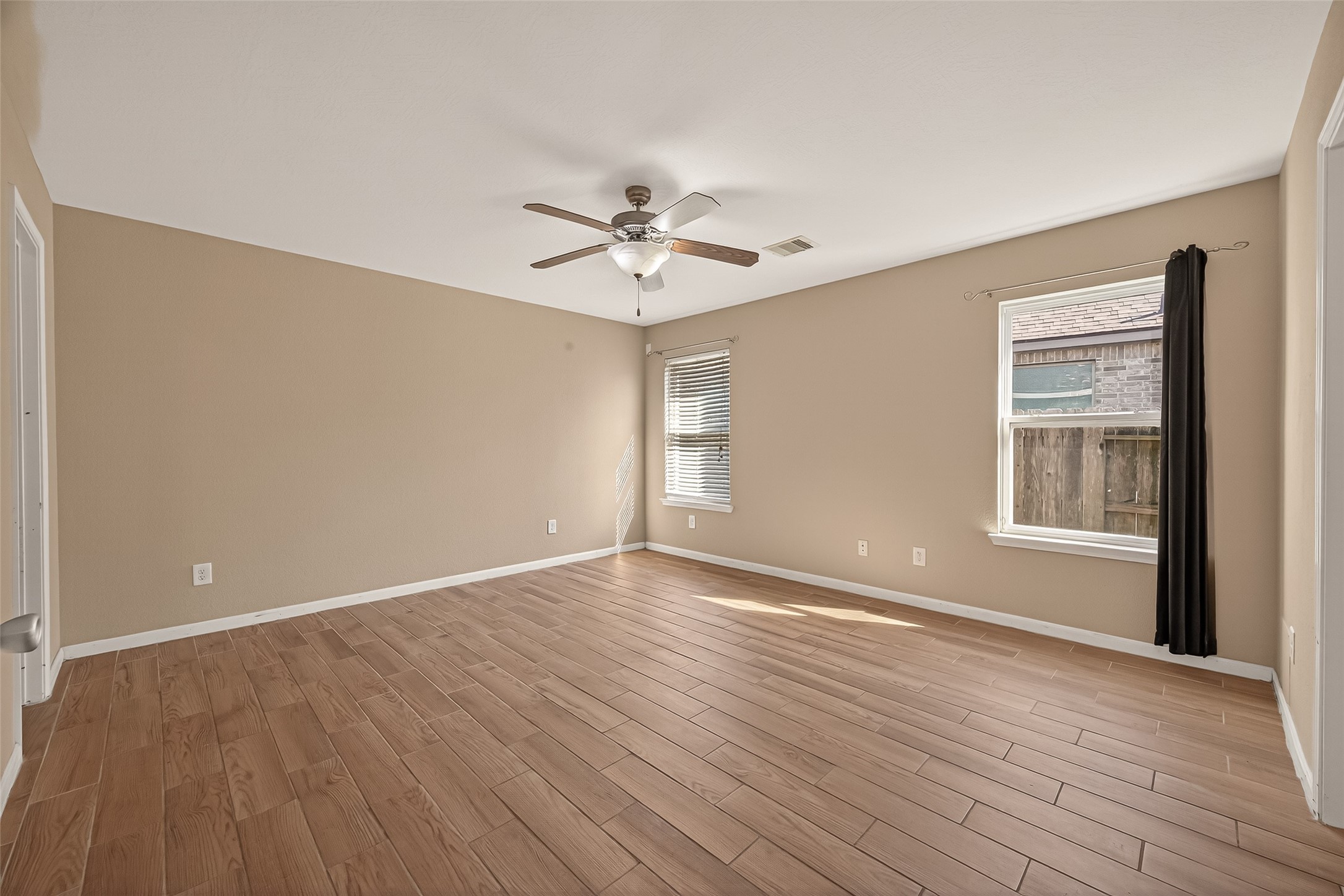 4515 Apache Point Drive Humble, TX 77396 - Photo 26 of 36 wooden floor in an empty room with a window