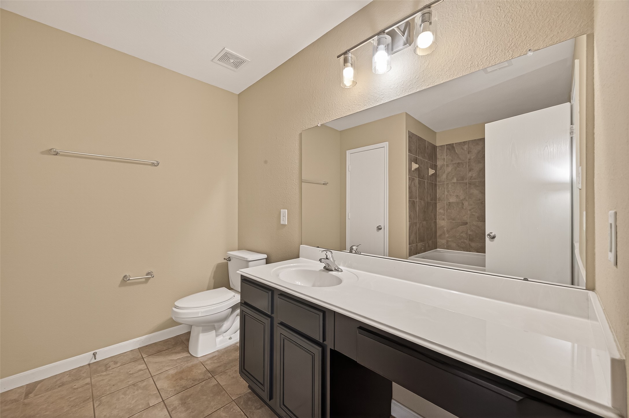 4515 Apache Point Drive Humble, TX 77396 - Photo 29 of 36 a bathroom with a sink a toilet and a large mirror
