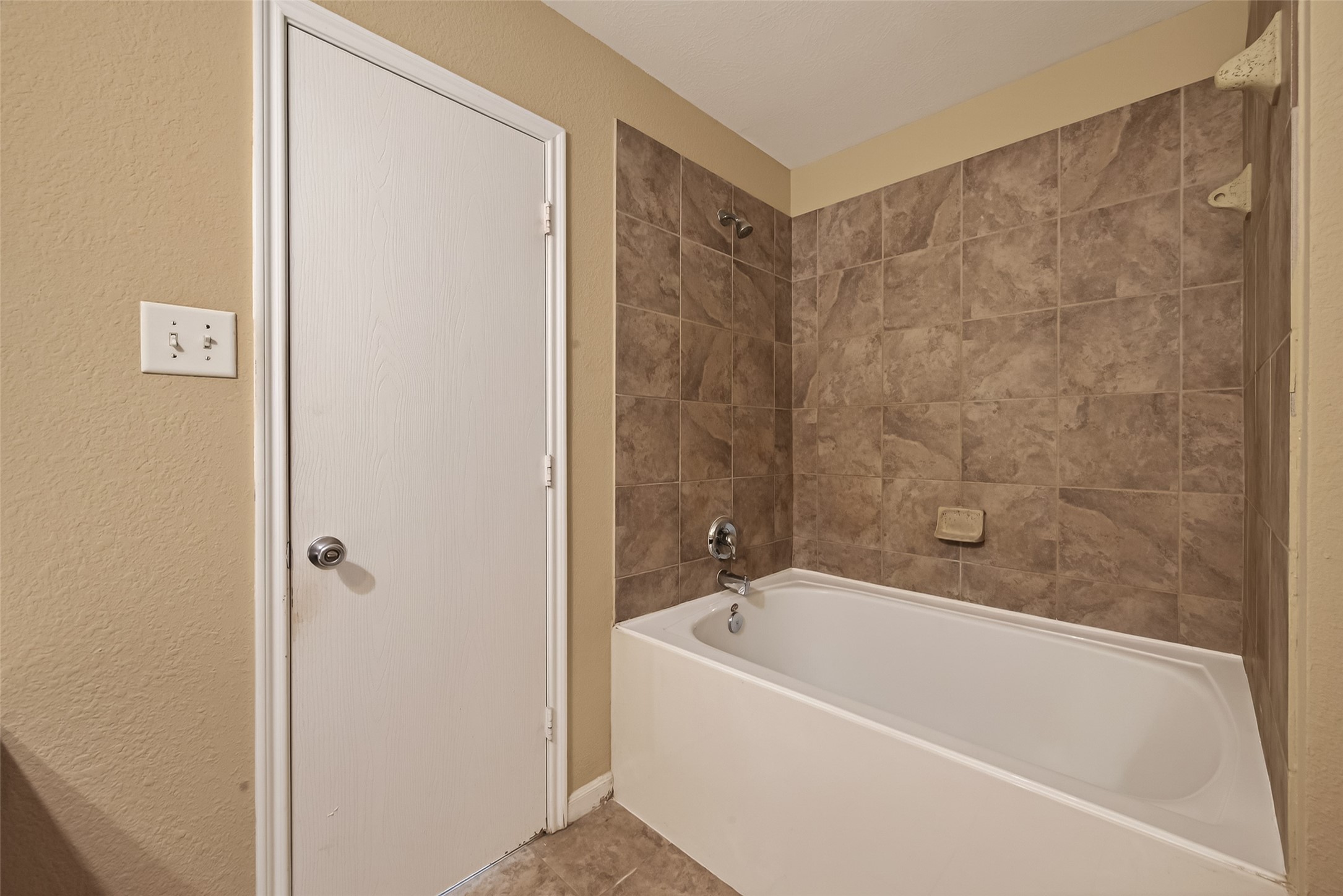 4515 Apache Point Drive Humble, TX 77396 - Photo 31 of 36 a bathroom with a bathtub and shower