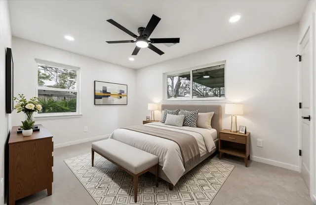 a bedroom with a large bed and a window