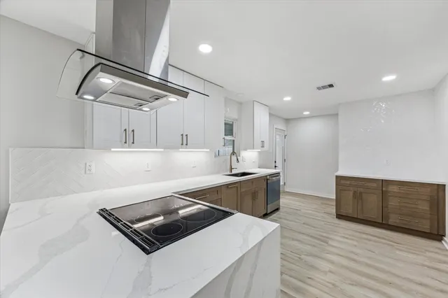 a kitchen with stainless steel appliances a sink and cabinets