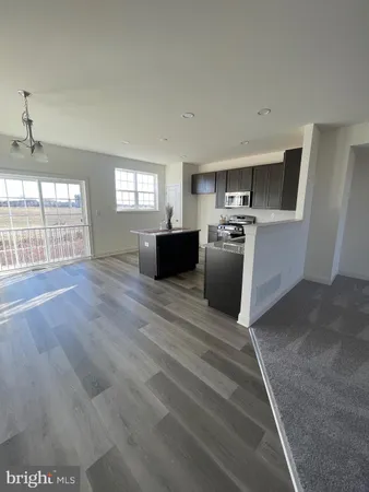 a kitchen with stainless steel appliances granite countertop a sink a stove and a refrigerator