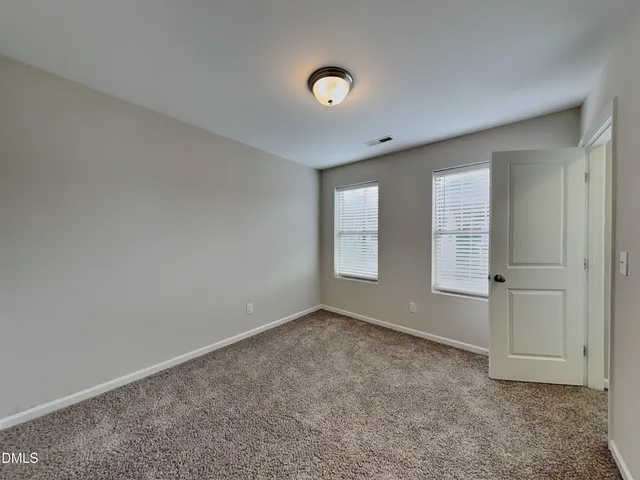 an empty room with a empty space and windows