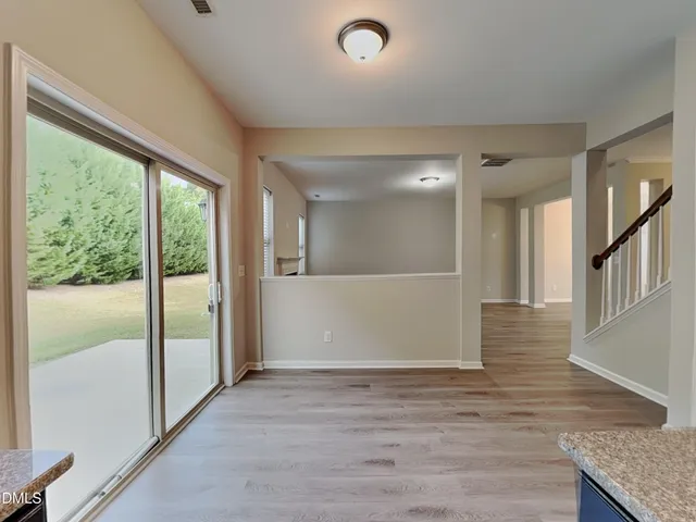 a view of an empty room with glass door