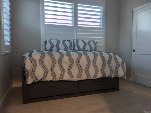 a bedroom with a bed and window
