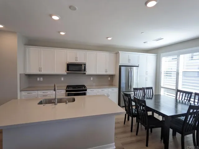 a view of a dining room with furniture and window